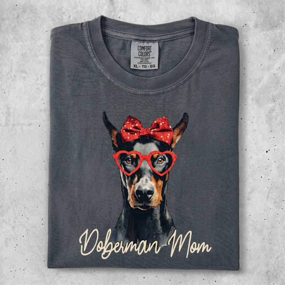 Doberman Mom t-shirt with heart glasses and red bow.