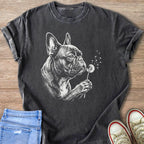 French bulldog blowing on a dandelion on a charcoal t-shirt.