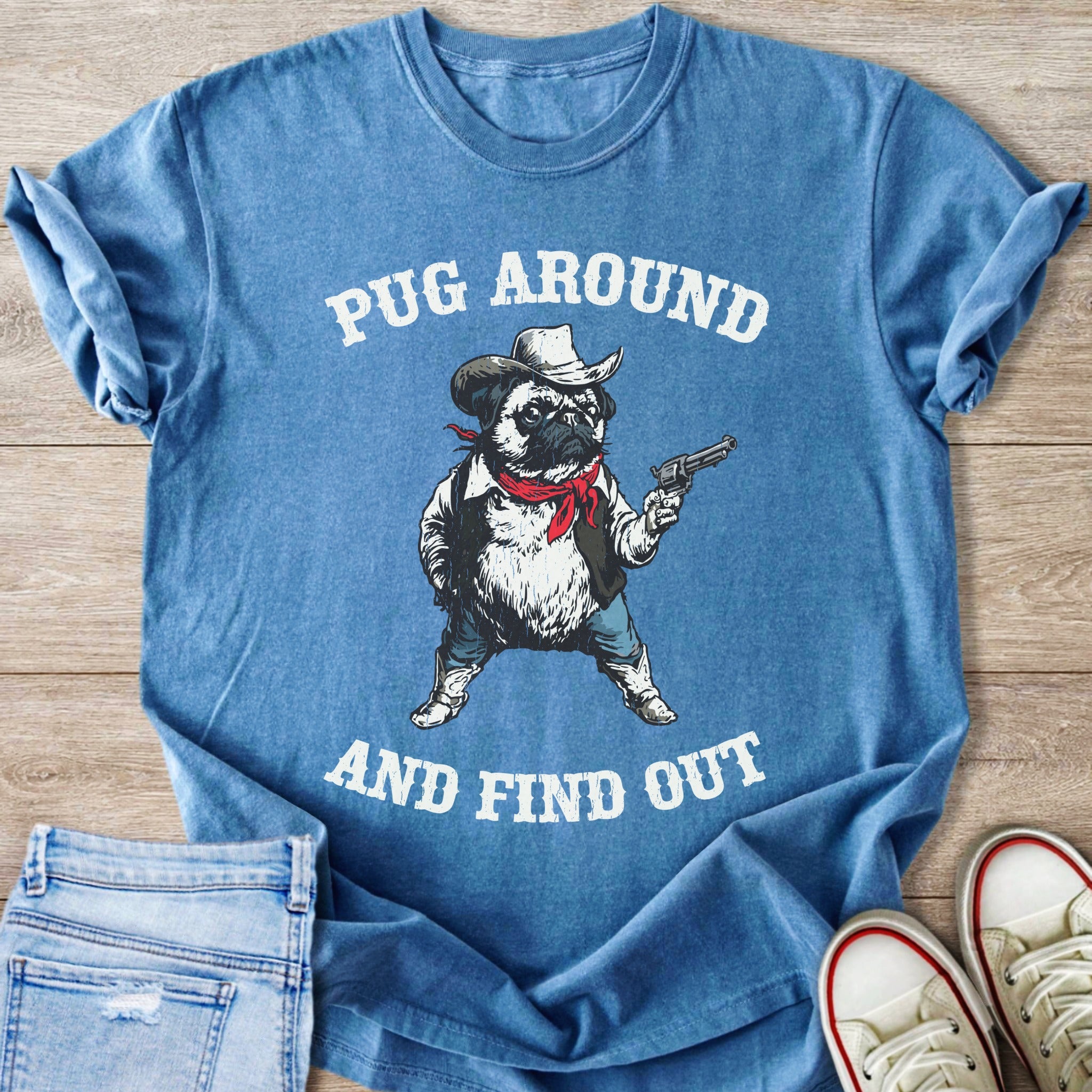 Blue t-shirt with a pug in a cowboy hat holding a pistol and printed text.