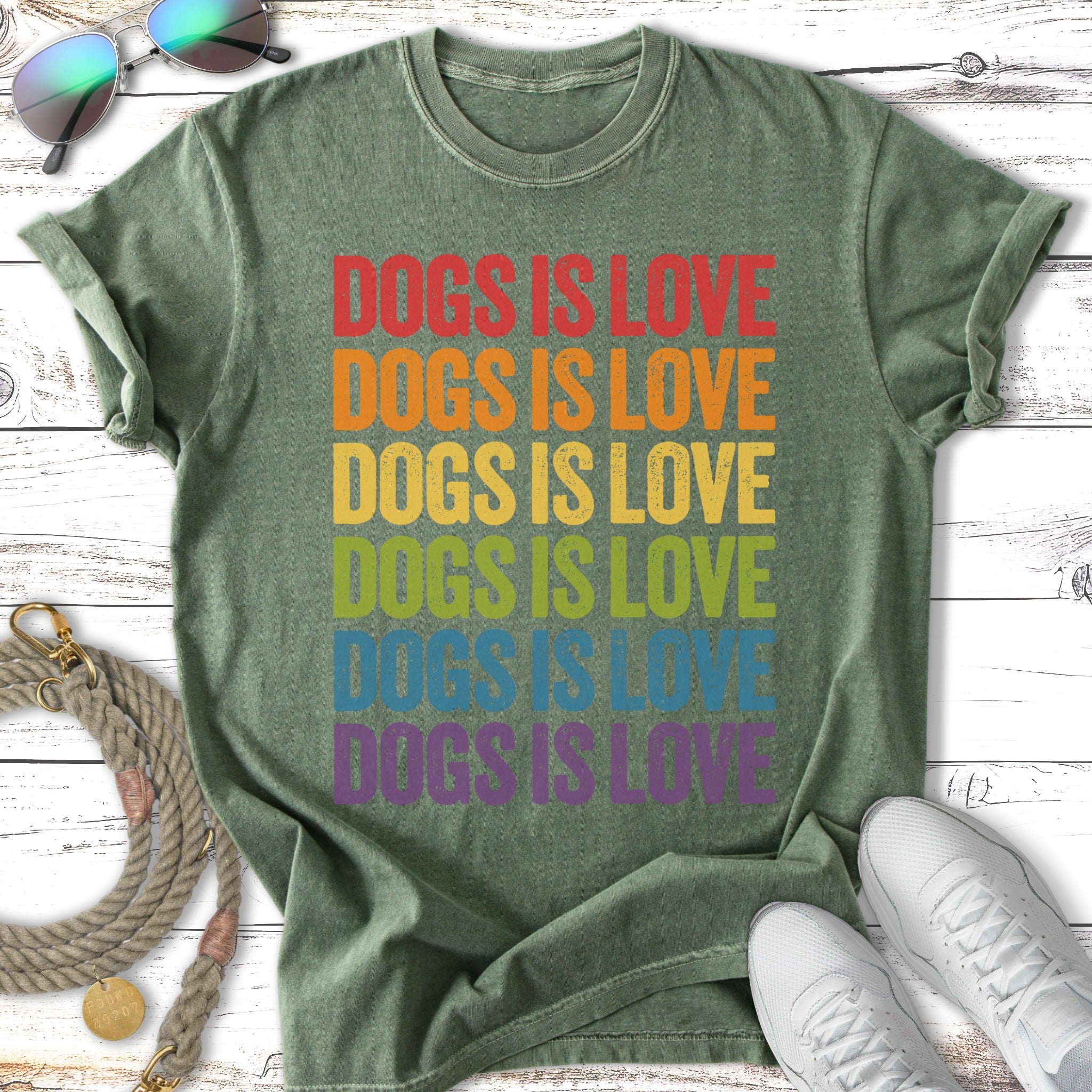Green t-shirt with "Dogs is Love" in rainbow gradient lettering.