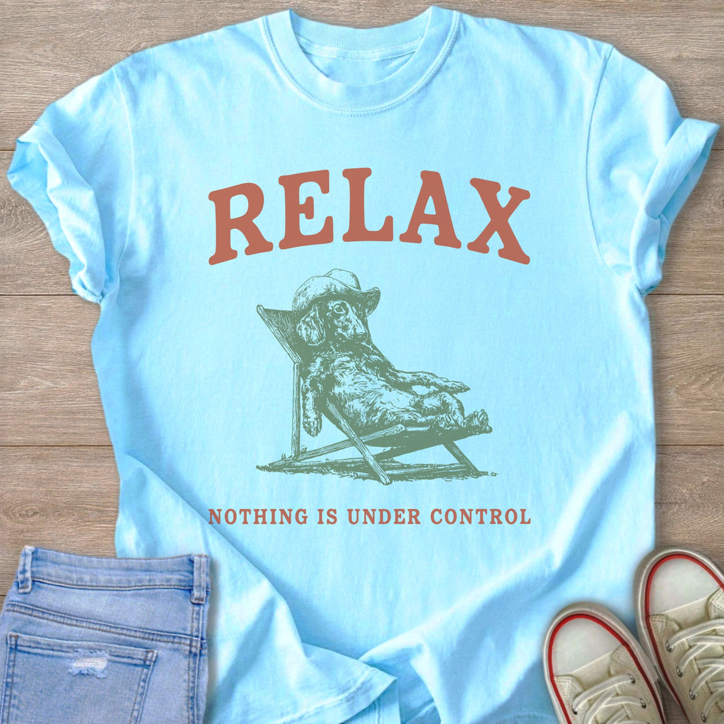 Light blue t-shirt with text "RELAX" and a drawing of a dog on a lounge chair.