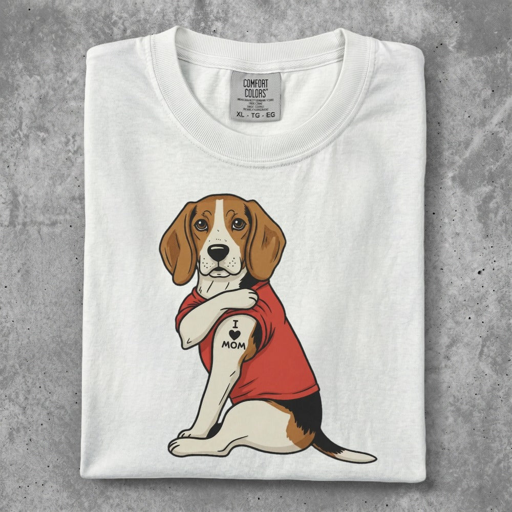 Beagle wearing a red shirt with "I love mom" tattoo on arm.