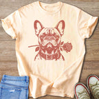 French bulldog with a rose in its mouth printed on a light peach t-shirt.