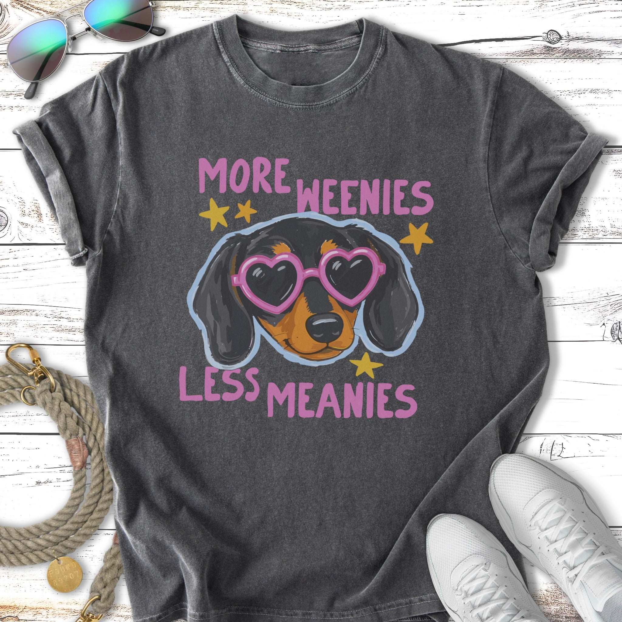 Dachshund wearing heart sunglasses with text "More Weenies Less Meanies."