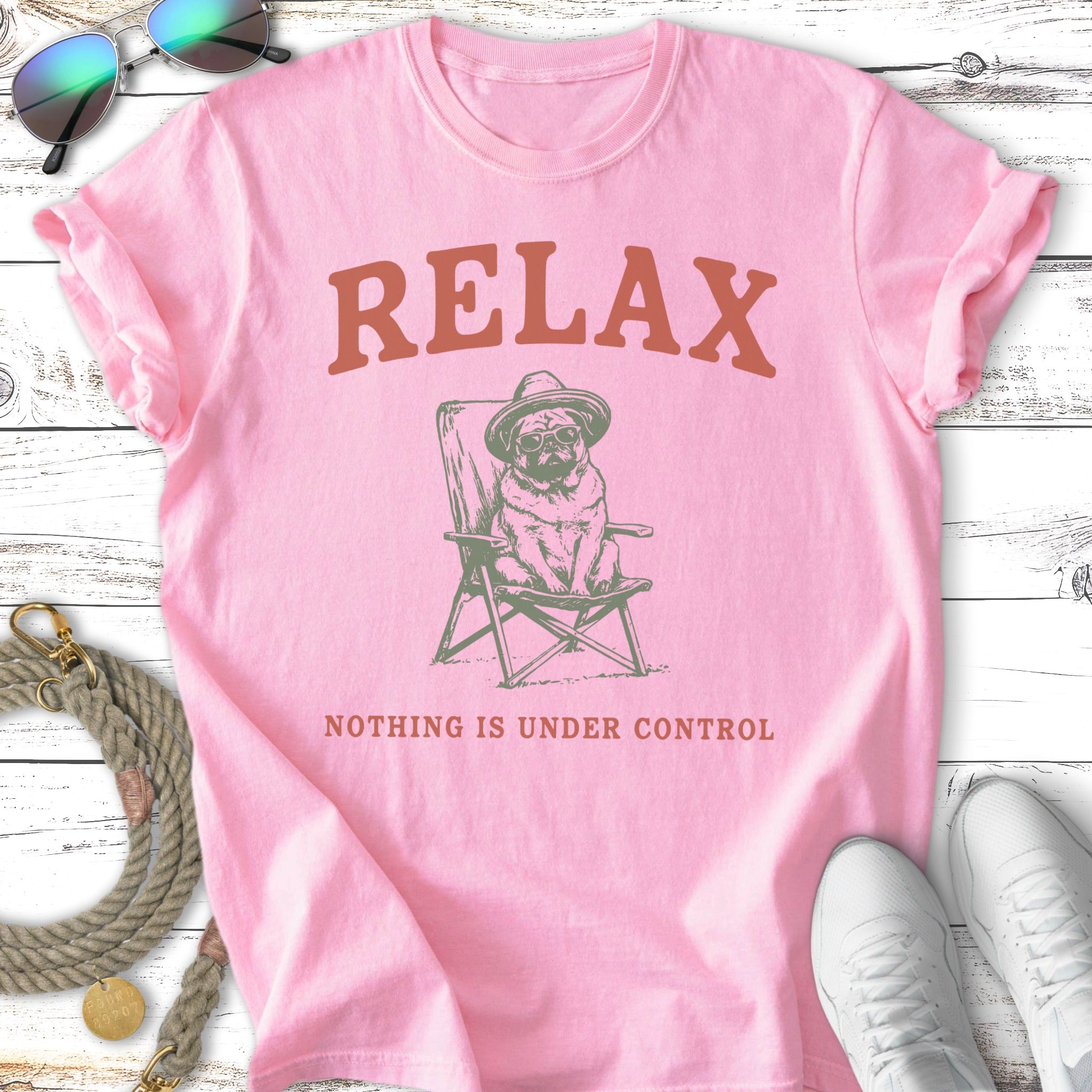 Pink t-shirt with pug in chair and text "RELAX NOTHING IS UNDER CONTROL".