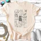 Line drawing of twelve different cats in a grid on a cream t-shirt.