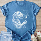 Blue t-shirt with a white line drawing of a dog blowing on a dandelion.