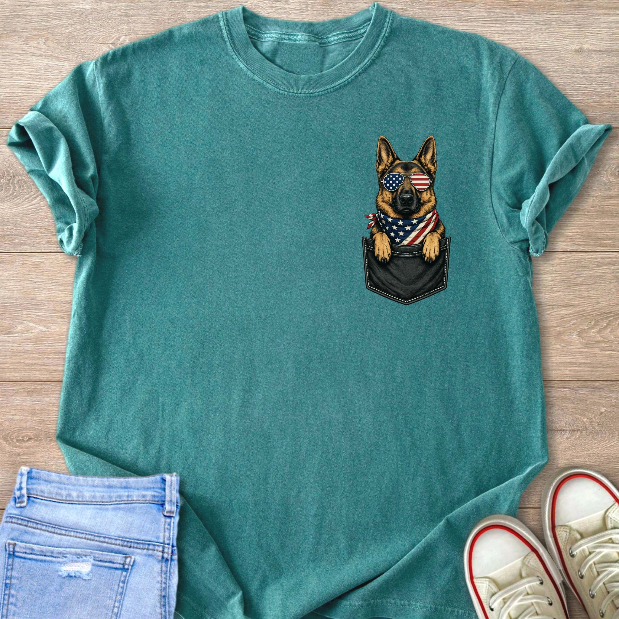 German Shepherd wearing American flag bandana and sunglasses peeking from a pocket.