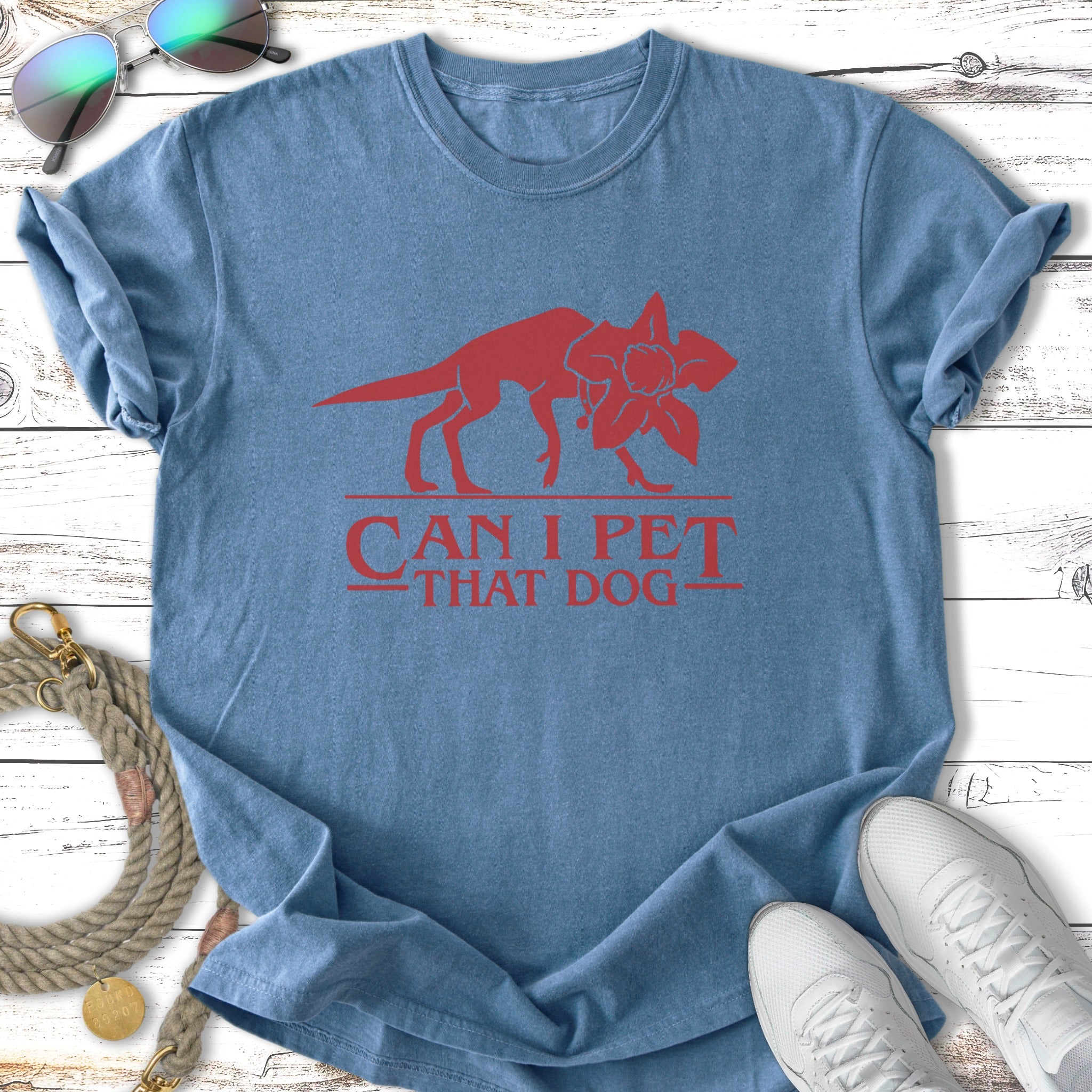 Blue t-shirt with red graphic of Demogorgon and text "Can I Pet That Dog".