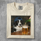 Border collie in a baseball cap with beer being poured into its mug.