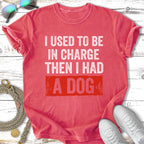 Red t-shirt with "I used to be in charge, then I had a dog" text.