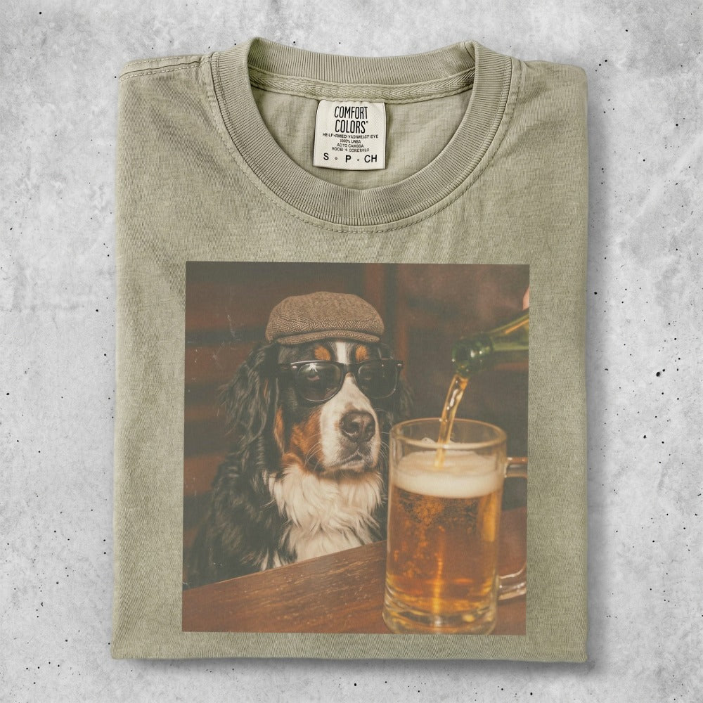 Bernese Mountain Dog wearing sunglasses and a hat, watching beer being poured.