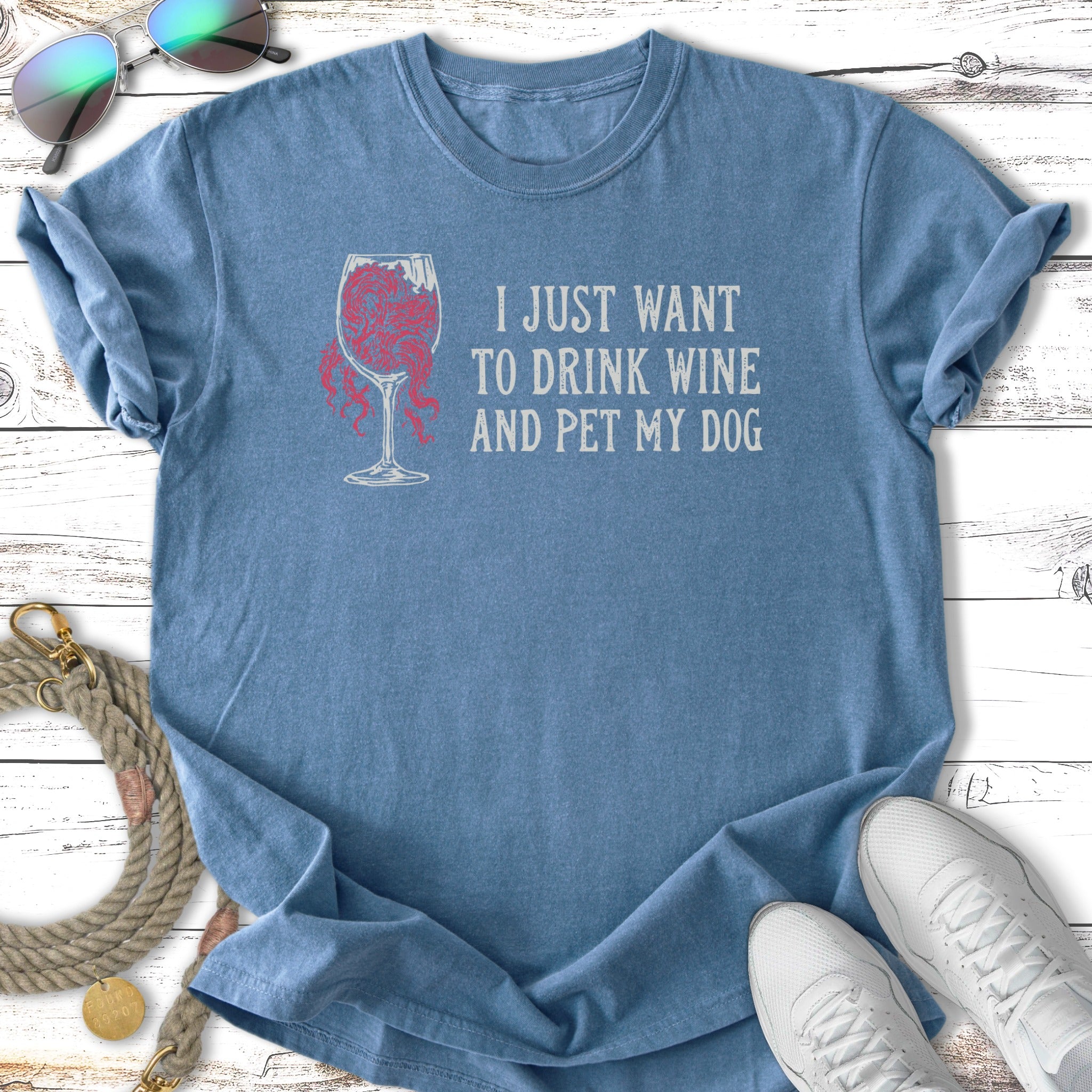 Blue t-shirt with "I just want to drink wine and pet my dog" text.