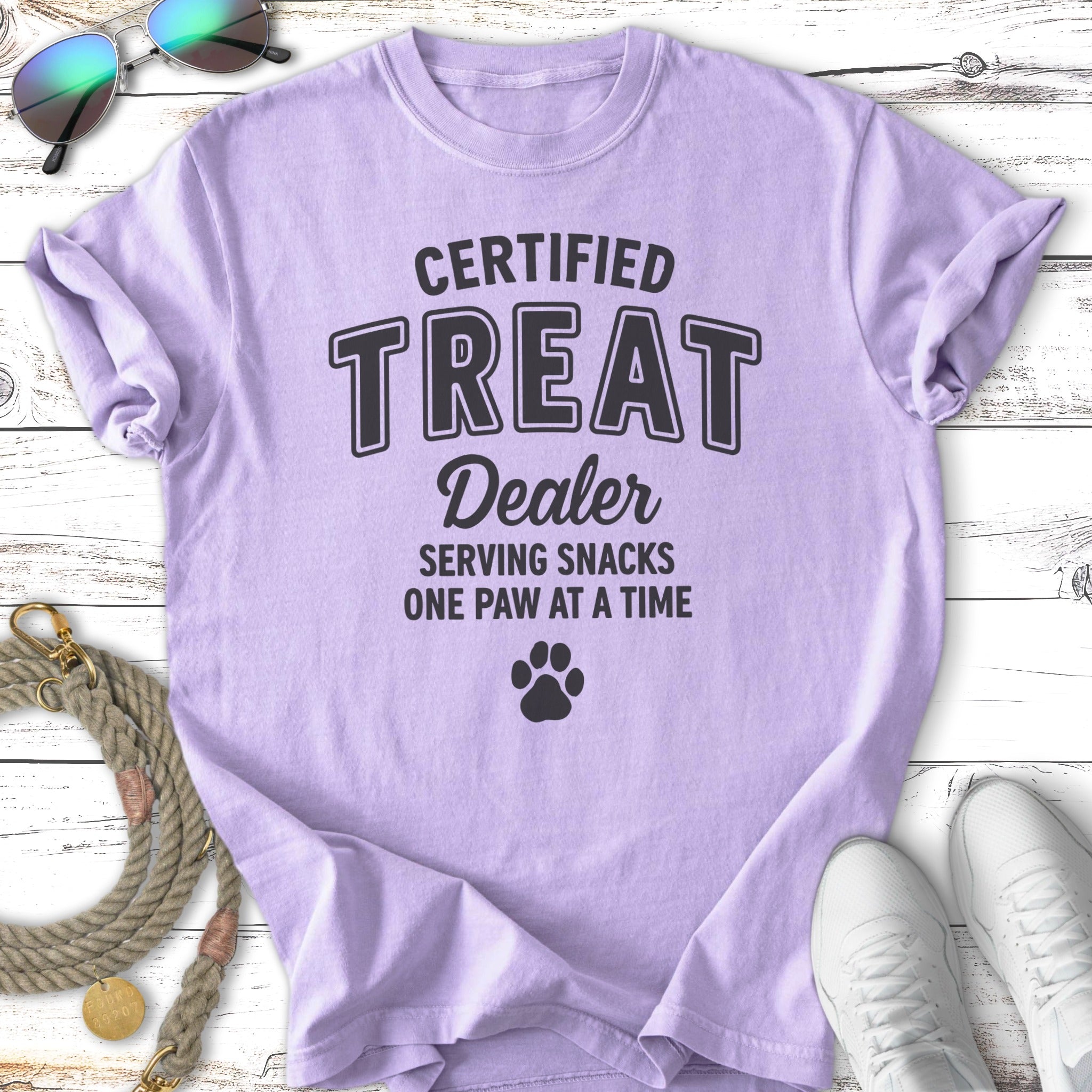 Lavender t-shirt with "Certified Treat Dealer" and paw print graphic.