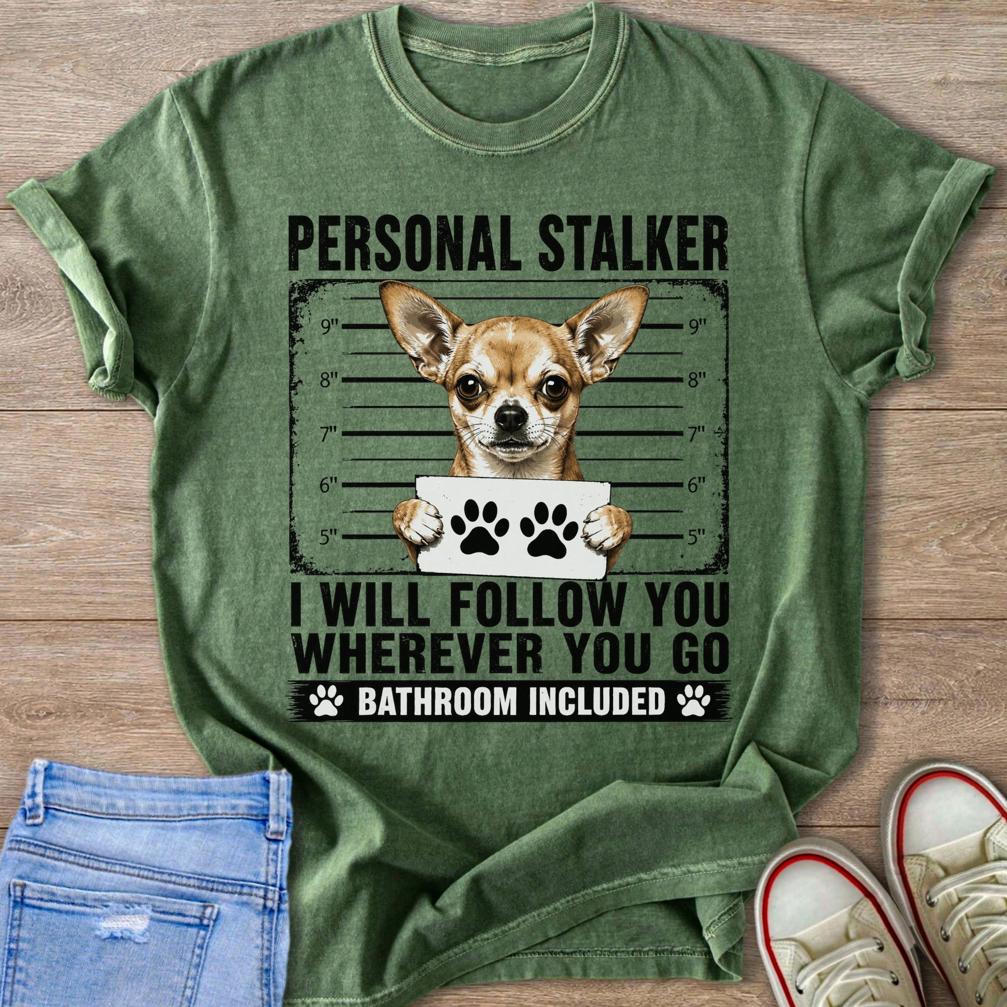 Green t-shirt with a chihuahua in a mugshot, text reads "Personal Stalker: I will follow you wherever you go. Bathroom included."