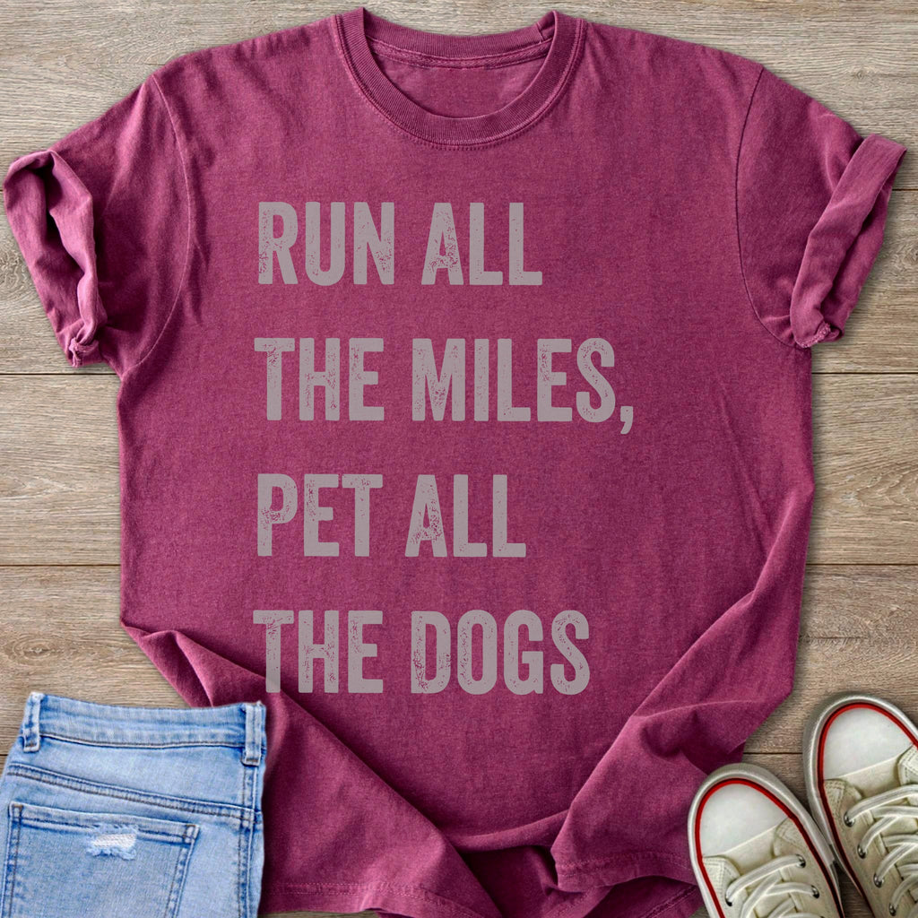 Maroon t-shirt with faded gray text "RUN ALL THE MILES, PET ALL THE DOGS".