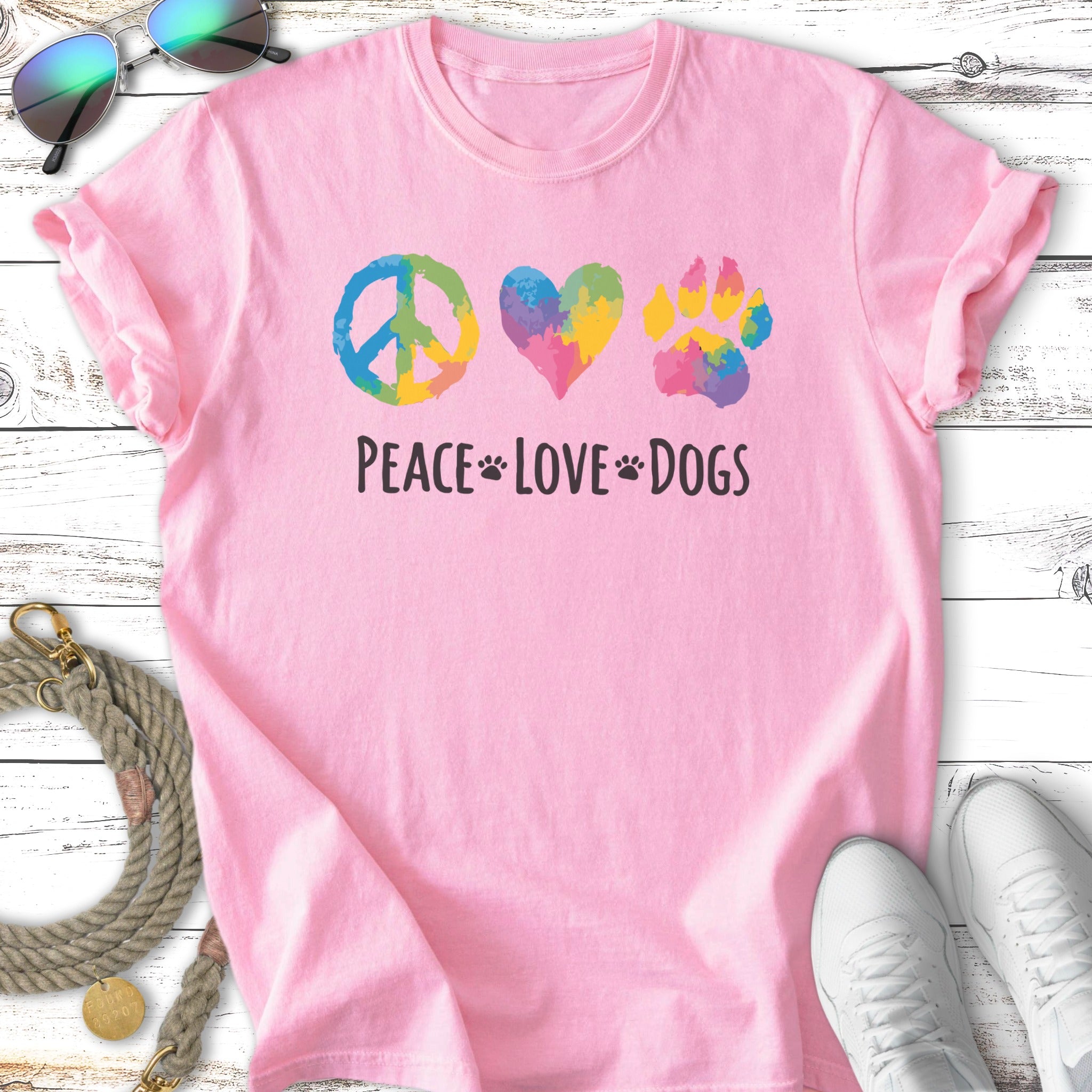 Pink t-shirt with peace, heart, and paw print icons and "Peace Love Dogs" text.