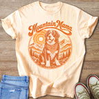 T-shirt with "Mountain Mama" text and dog in mountainous landscape graphic.