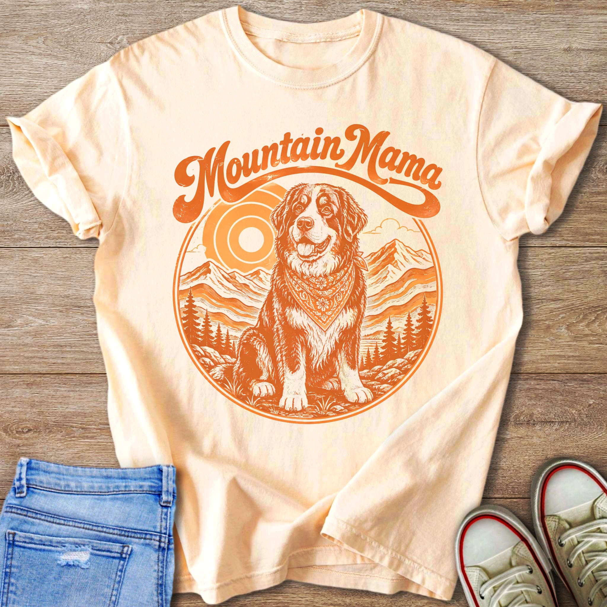 T-shirt with "Mountain Mama" text and dog in mountainous landscape graphic.