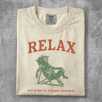T-shirt with "RELAX NOTHING IS UNDER CONTROL" text and reclining figure.