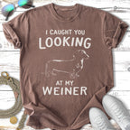 Brown t-shirt with a dachshund and text that reads "I caught you looking at my wiener".