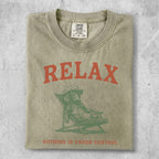 T-shirt with a graphic of a dog lounging in a chair and the text "RELAX NOTHING IS UNDER CONTROL".