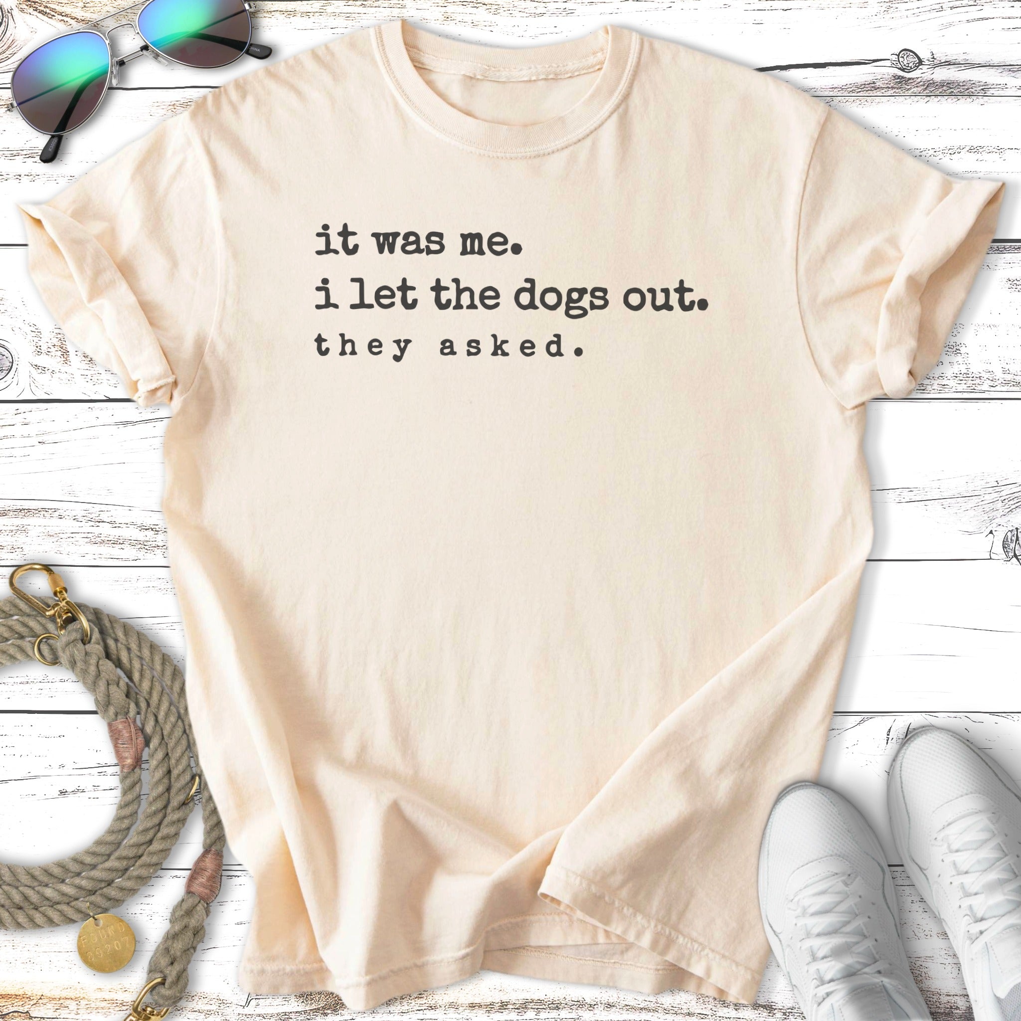 Cream t-shirt with "it was me. i let the dogs out. they asked." text.