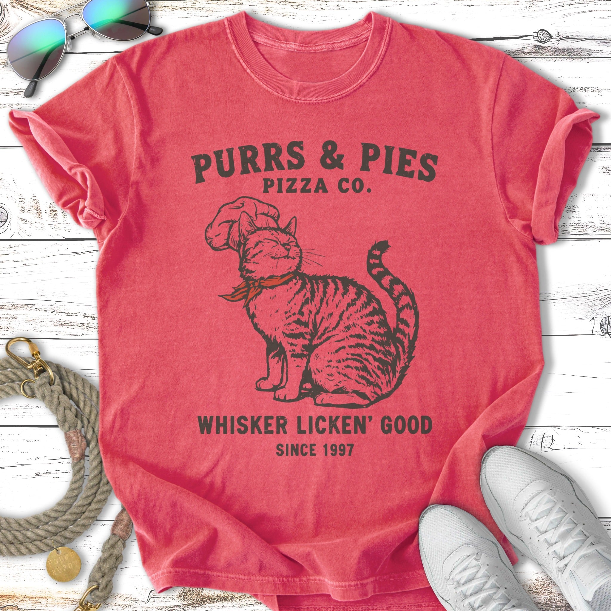 Purrs & Pies Pizza Co. t-shirt with a cat graphic and text.