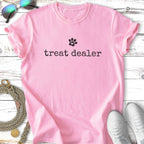 Pink t-shirt with "treat dealer" and paw print graphic.