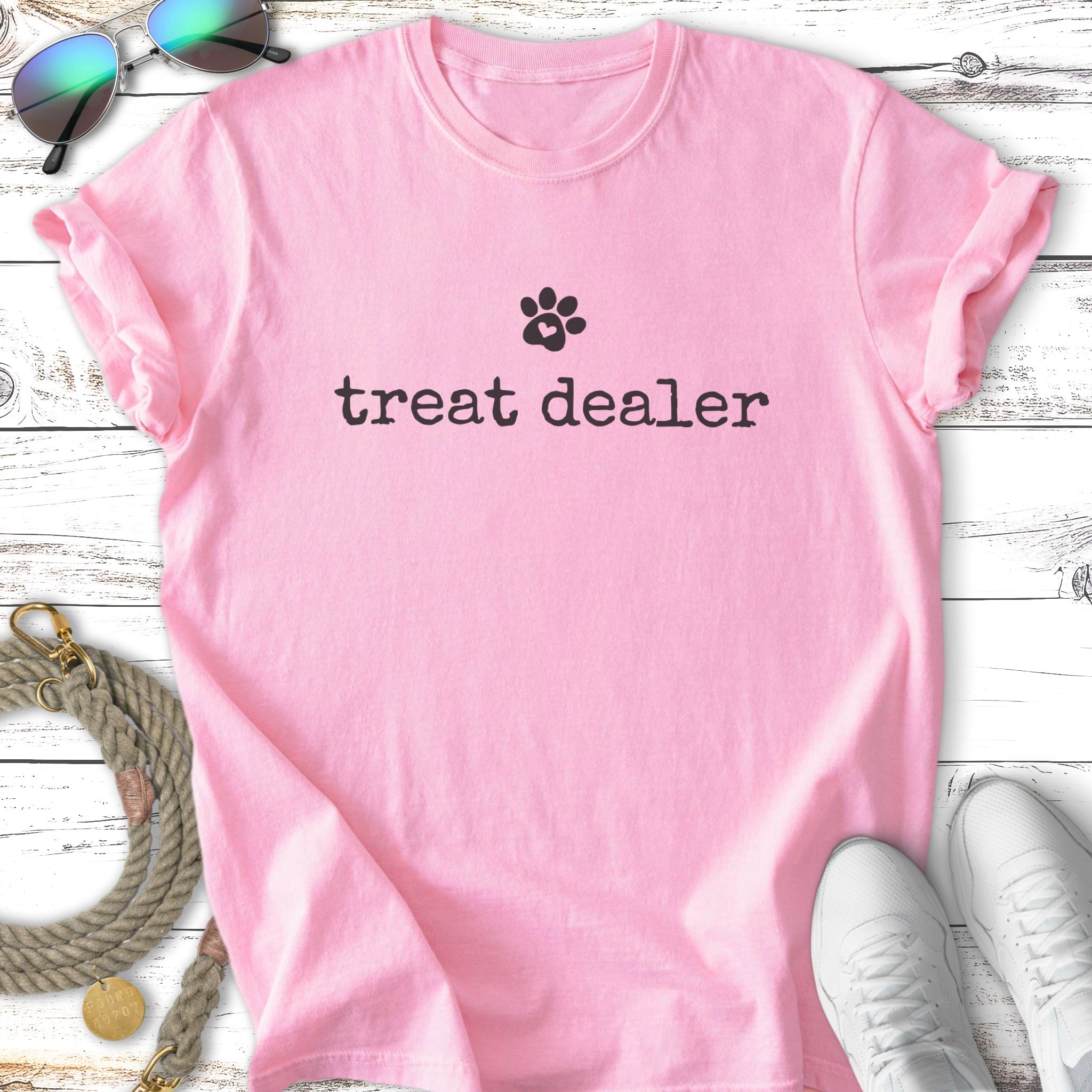 Pink t-shirt with "treat dealer" and paw print graphic.