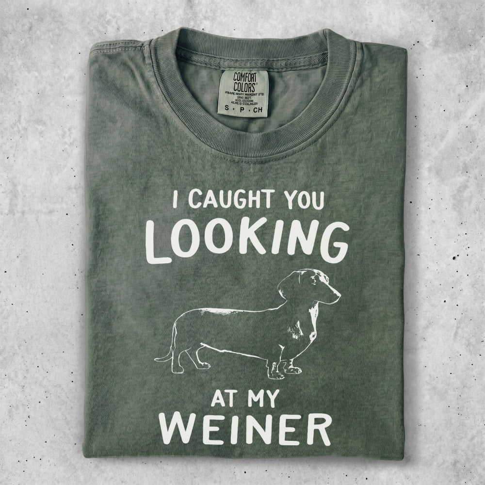 Green t-shirt with white text "I CAUGHT YOU LOOKING AT MY WEINER" and dachshund graphic.