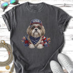 Dog wearing USA bandana and sunglasses with patriotic decorations.