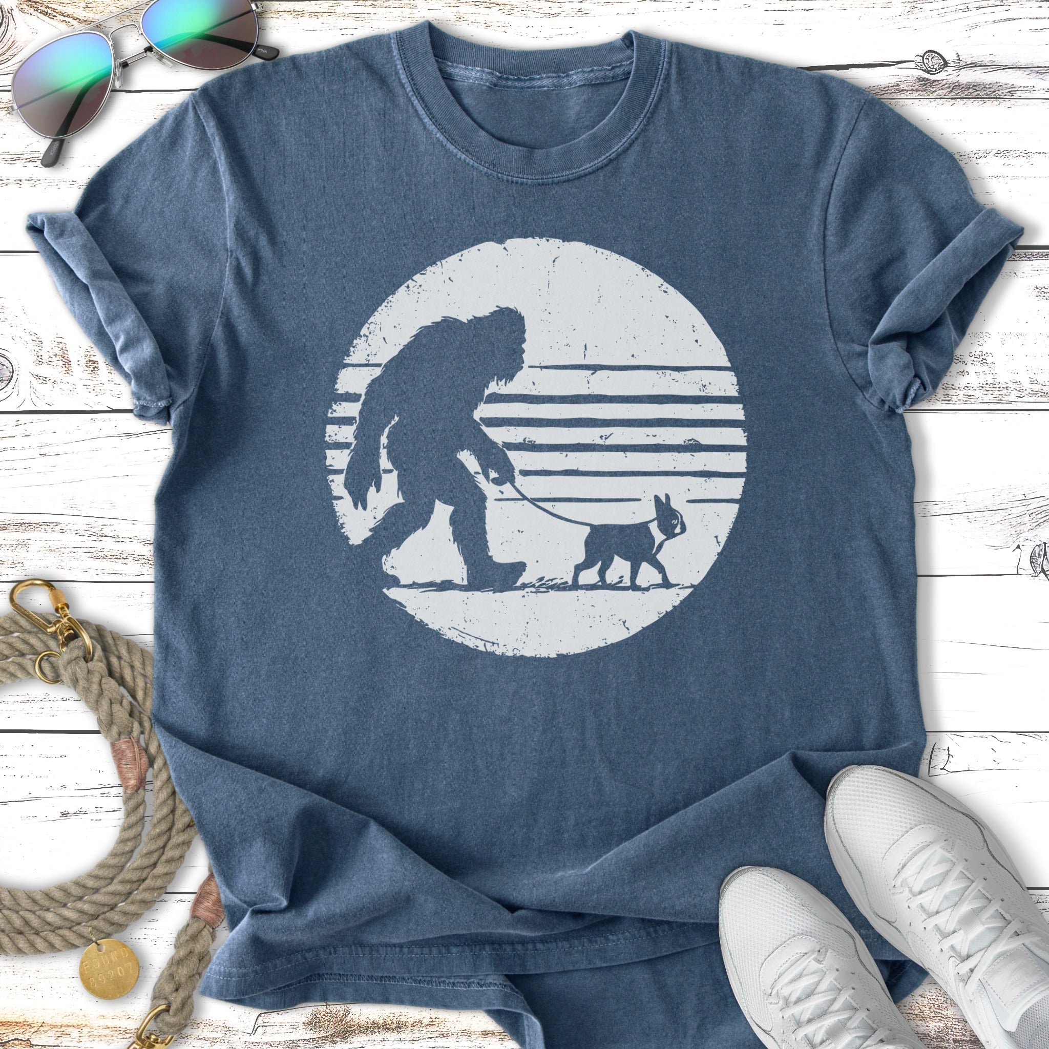 Bigfoot walking a French bulldog on a leash, vintage distressed design.