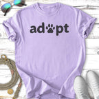 Lavender t-shirt with "adopt" in black text and paw print.