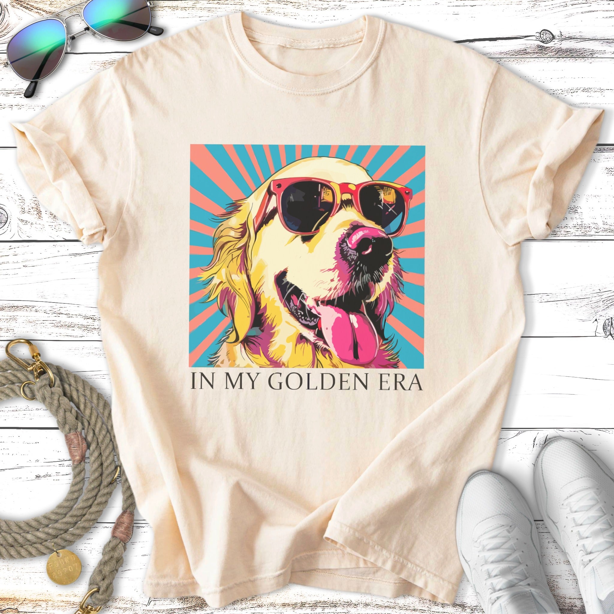 Golden retriever wearing sunglasses on a peach shirt with text "IN MY GOLDEN ERA".