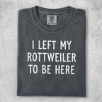 Dark grey t-shirt with "I LEFT MY ROTTWEILER TO BE HERE" text.