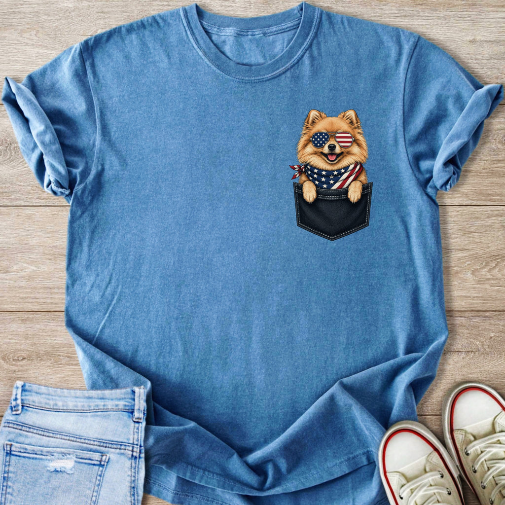 Blue t-shirt with a Pomeranian dog in a pocket wearing American flag bandana and sunglasses.
