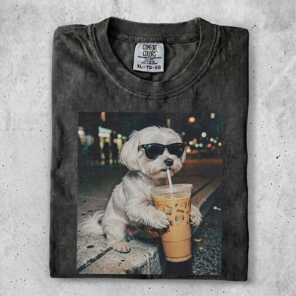 White dog in sunglasses drinks iced coffee from a plastic cup.