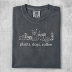 Dark gray t-shirt with white line art of plants, dogs, and coffee cups.