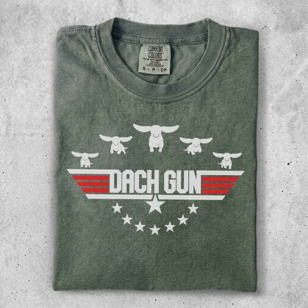 Green t-shirt with "DACH GUN" and dachshund silhouettes in a wing design.