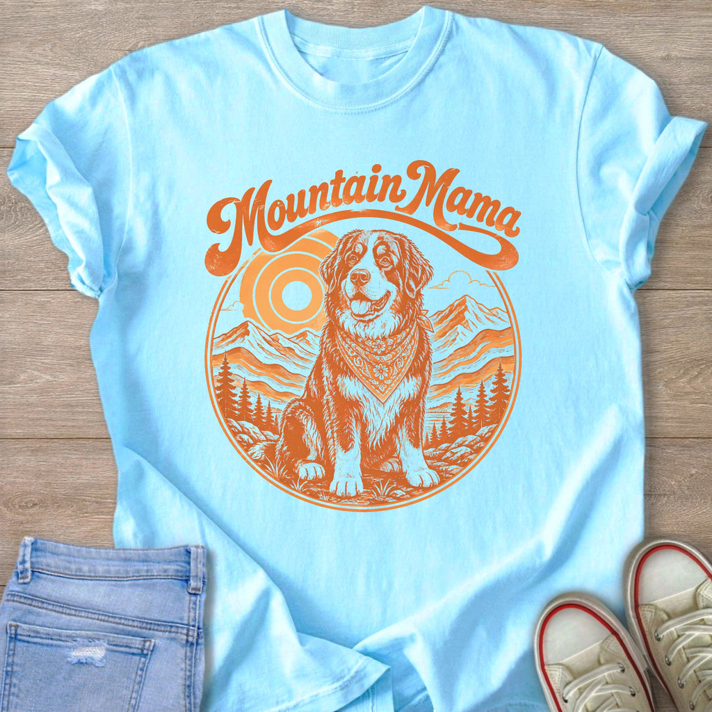 Light blue t-shirt with orange "Mountain Mama" graphic featuring a dog and mountains.