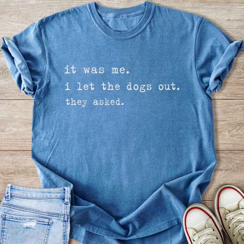 Blue t-shirt with white text: "it was me. i let the dogs out. they asked."