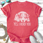 Coral t-shirt with a white dog illustration and text "YES, I HERD YOU".