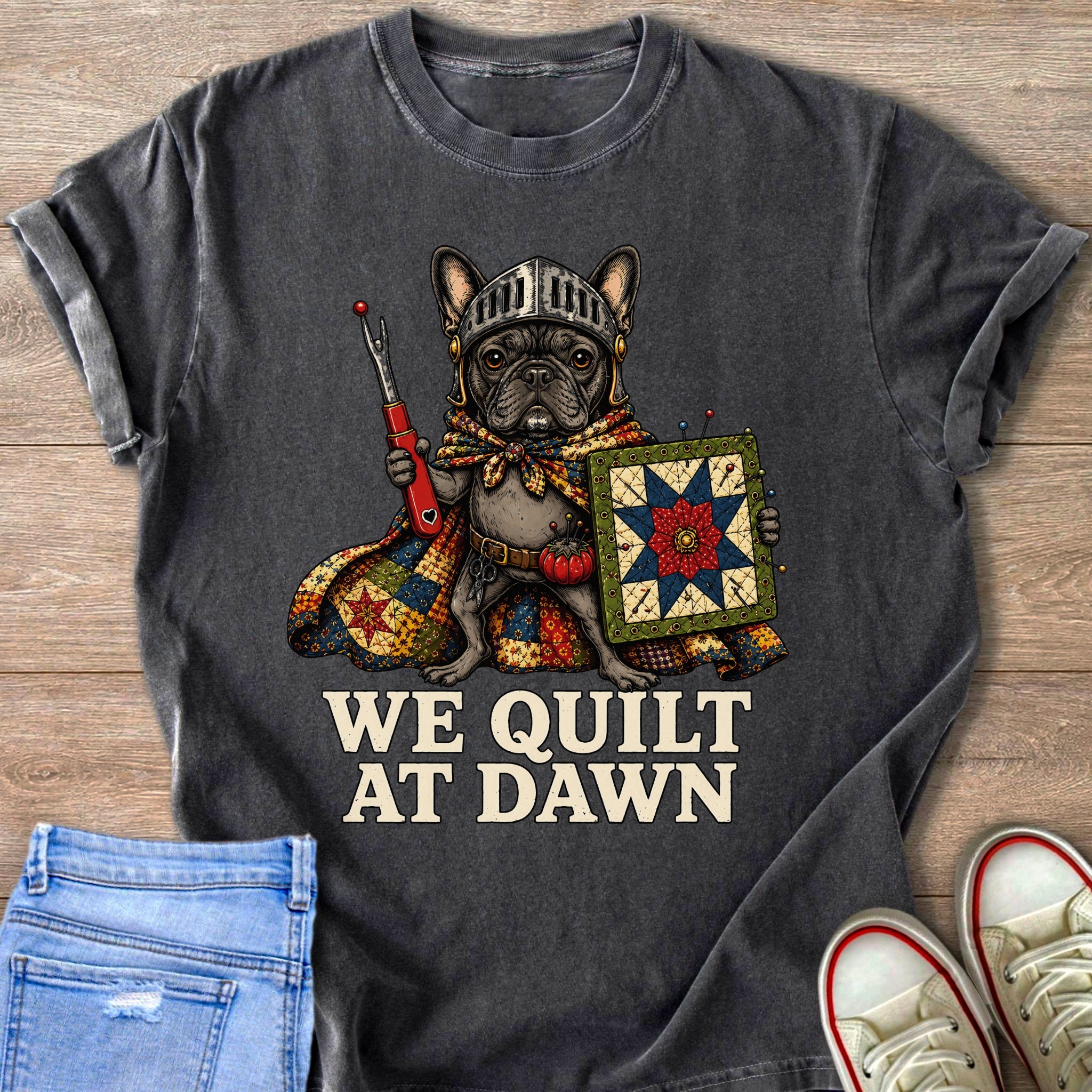 French bulldog knight holding sewing tools and a quilt, reads "WE QUILT AT DAWN".