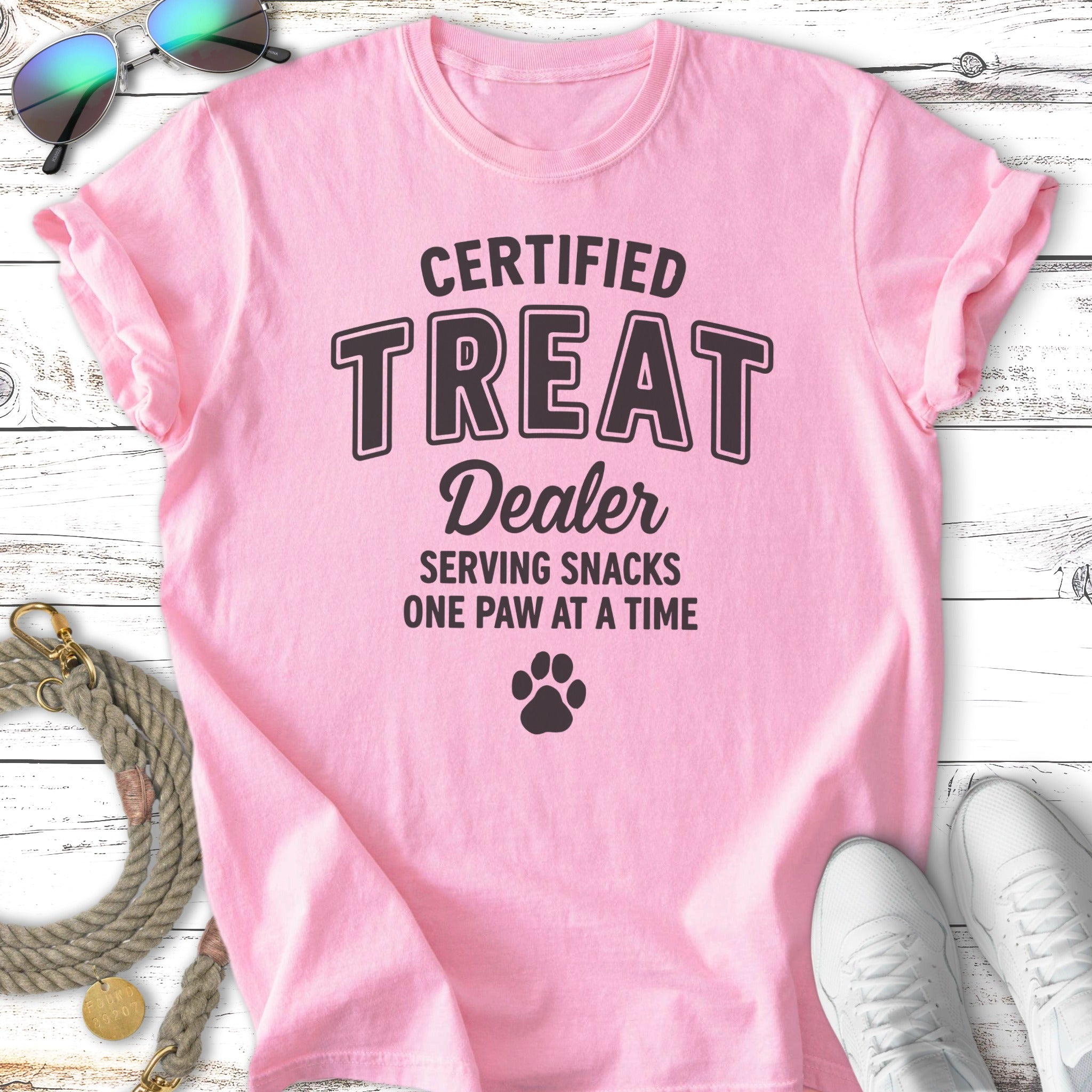 Pink t-shirt with "Certified Treat Dealer" and paw print graphic.