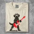 Black dog with red electric guitar graphic on a cream t-shirt.