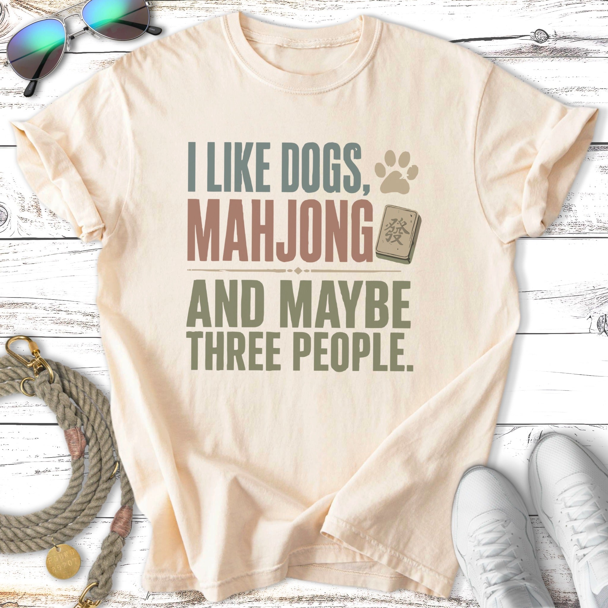 Cream t-shirt with "I like dogs, mahjong and maybe three people" text.