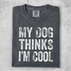 Dark gray t-shirt with white text "MY DOG THINKS I'M COOL".
