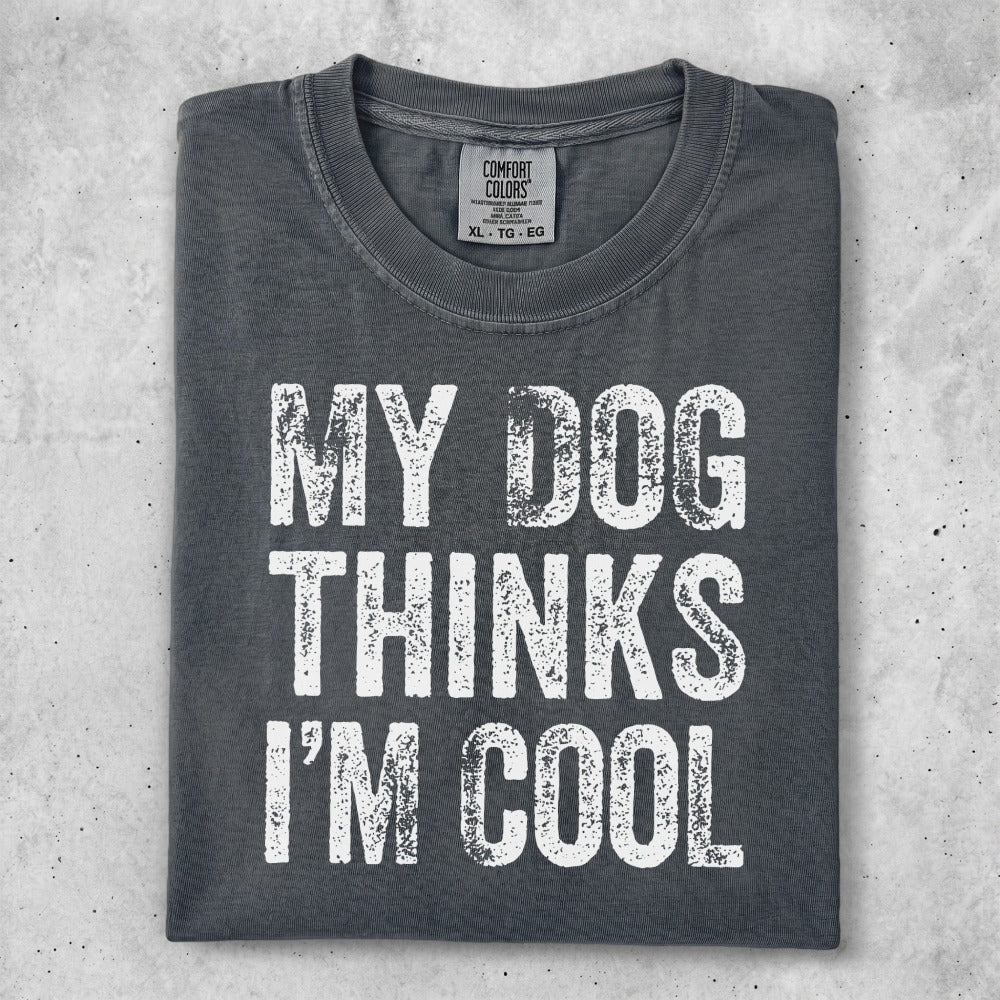 Dark gray t-shirt with white text "MY DOG THINKS I'M COOL".