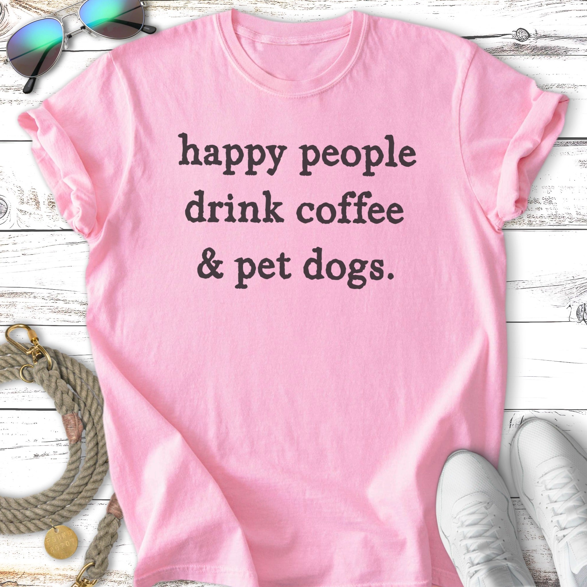 Pink t-shirt with "happy people drink coffee & pet dogs" text.